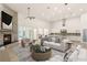 Bright living room with fireplace, and modern furniture showcasing an open floor plan to the kitchen at 1725 Bannie Ave, Las Vegas, NV 89102