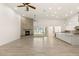 Living room featuring a stone fireplace, tile floors, and an open layout leading to the kitchen area at 1725 Bannie Ave, Las Vegas, NV 89102