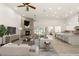 Staged living room with a stone fireplace, modern furniture, and an open layout connecting to the kitchen at 1725 Bannie Ave, Las Vegas, NV 89102