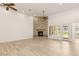 Bright living room with a stone fireplace, ceiling fans, and natural light from the nearby windows at 1725 Bannie Ave, Las Vegas, NV 89102