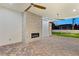 Outdoor patio featuring a stone fireplace, ceiling fans, and decorative paver flooring at 1725 Bannie Ave, Las Vegas, NV 89102