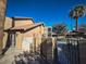 Landscaped backyard with a stucco wall and wrought iron gate at 2205 Alia Ct, Las Vegas, NV 89102