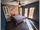 Cozy bedroom with brick feature wall, built in shelves, and French doors at 2205 Alia Ct, Las Vegas, NV 89102