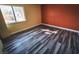 Bright bedroom with wood-look tile flooring and an accent wall at 2205 Alia Ct, Las Vegas, NV 89102