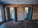 Two large walk-in closets with dark teal doors and stone wall accents at 2205 Alia Ct, Las Vegas, NV 89102