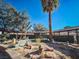 Landscaped backyard with a variety of desert plants and artwork at 2205 Alia Ct, Las Vegas, NV 89102