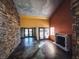 Living room with high ceilings, stone walls, and fireplace at 2205 Alia Ct, Las Vegas, NV 89102