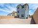 The backyard has a gravel ground cover and a block wall at 633 N Water St, Henderson, NV 89015