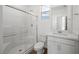Well-lit bathroom with modern fixtures, glass-enclosed shower, and sleek vanity at 633 N Water St, Henderson, NV 89015
