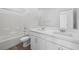 Modern bathroom boasts double sinks, stylish fixtures, and a shower-tub combo with tile surround at 633 N Water St, Henderson, NV 89015