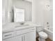 Modern bathroom vanity featuring a large mirror, and shower with tile surround at 633 N Water St, Henderson, NV 89015