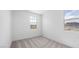 This bedroom offers neutral walls, carpet, and bright views from the home's window at 633 N Water St, Henderson, NV 89015