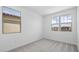 Bright bedroom with a neutral color palette and dual windows offering neighborhood views at 633 N Water St, Henderson, NV 89015