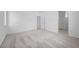 Bright bedroom features neutral carpet, white walls, and doorways to the bathroom at 633 N Water St, Henderson, NV 89015