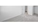 Bright bedroom features neutral carpet, white walls, and doorways to the bathroom and walk-in closet at 633 N Water St, Henderson, NV 89015