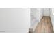 Inviting entryway features wood-look tile flooring, carpeted stairs, and white walls at 633 N Water St, Henderson, NV 89015