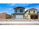 Charming two-story home with a two-car garage, brick driveway, and well-maintained landscaping at 633 N Water St, Henderson, NV 89015