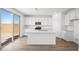 Modern kitchen features white cabinets, stainless steel appliances, and a spacious island at 633 N Water St, Henderson, NV 89015