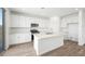 Contemporary kitchen featuring stainless steel appliances, white cabinets, and a center island at 633 N Water St, Henderson, NV 89015