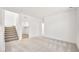 Spacious living area with stairs leading up, neutral carpet, and lots of natural light at 633 N Water St, Henderson, NV 89015