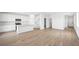 Open-concept living space with wood-look floors, a modern kitchen, and abundant natural light at 633 N Water St, Henderson, NV 89015