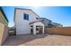 This backyard features low-maintenance desert landscaping, block wall and covered patio at 647 N Water St, Henderson, NV 89015