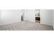 Spacious bedroom with an ensuite bathroom and neutral carpeting at 647 N Water St, Henderson, NV 89015
