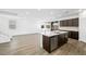 Bright, spacious kitchen with sleek stainless steel appliances and a large island with a sink at 647 N Water St, Henderson, NV 89015
