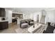 Open-concept living room boasts wood-look flooring, modern furnishings, and seamless flow into the kitchen area at 647 N Water St, Henderson, NV 89015
