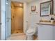 Tiled bathroom featuring glass shower doors, and a white sink with gold fixtures at 2747 Paradise Rd # 2206, Las Vegas, NV 89109