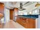 Modern kitchen featuring wood cabinets, stainless steel appliances, granite counters, and tiled floors at 2747 Paradise Rd # 2206, Las Vegas, NV 89109