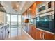 Modern kitchen with stainless steel appliances, custom cabinetry, and panoramic city views through floor-to-ceiling windows at 2747 Paradise Rd # 2206, Las Vegas, NV 89109