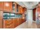 Modern kitchen featuring wood cabinets, granite counters, stainless steel appliances and modern lighting at 2747 Paradise Rd # 2206, Las Vegas, NV 89109