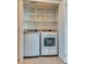 Convenient laundry area equipped with a washer, dryer, and built-in shelving for efficient storage at 2747 Paradise Rd # 2206, Las Vegas, NV 89109