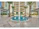 Inviting pool area surrounded by palm trees, lounge chairs, and a high-rise condo building at 2747 Paradise Rd # 2206, Las Vegas, NV 89109