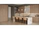 Modern kitchen with marble countertops, sleek cabinetry, stainless steel appliances, and counter seating at 323 Wanda Rd, Henderson, NV 89002