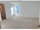 Large bedroom with window and neutral carpet at 4747 Illustria Ave, Las Vegas, NV 89141