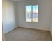 Spacious bedroom with neutral carpeting and window at 4747 Illustria Ave, Las Vegas, NV 89141