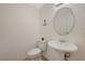 Simple bathroom with pedestal sink and round mirror at 537 Kristin Ln, Henderson, NV 89011