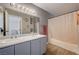 Bathroom boasts double sinks, a shower/tub combo, and wood-look floors at 537 Kristin Ln, Henderson, NV 89011