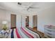 Spacious bedroom with ensuite bathroom access and striped bedding at 537 Kristin Ln, Henderson, NV 89011
