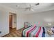 Bright bedroom features wood-look floors, ensuite bath, and striped bedding at 537 Kristin Ln, Henderson, NV 89011