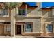 Tan stucco exterior of charming two-story home with wood accents at 537 Kristin Ln, Henderson, NV 89011