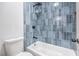 Modern bathroom with blue tile shower, bathtub, and updated fixtures at 5604 Island Breeze Ct, Las Vegas, NV 89130