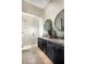 Modern bathroom with double vanity, large mirror, and walk-in shower at 655 Agate Bridge St, Las Vegas, NV 89138