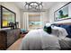 Spacious bedroom with large windows, comfortable bed, and stylish decor at 655 Agate Bridge St, Las Vegas, NV 89138