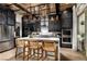 Modern kitchen with dark cabinetry, stainless steel appliances, and large island at 655 Agate Bridge St, Las Vegas, NV 89138