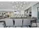 Spacious dining area with a long wooden table and modern chandelier at 667 Palisade Rim Dr, Henderson, NV 89012