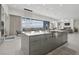 Modern kitchen island with waterfall edge and stainless steel sink at 667 Palisade Rim Dr, Henderson, NV 89012