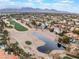 Aerial view of community with lake and mountains at 8736 Double Eagle Dr, Las Vegas, NV 89117